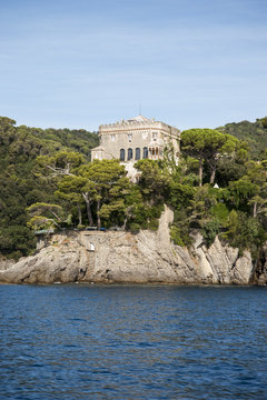 Portofino, Liguria Italia - watching the coast from the sea. View of the Paraggi Clastle , Villa Bonomi, residenza di Silvio Berlusconi, near Portofino with crystalline waters