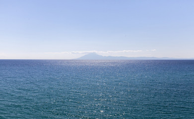 water surface with island Atos in Greece - obrazy, fototapety, plakaty