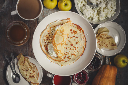 pancakes with cottage cheese and other sweet additives on the wood surface