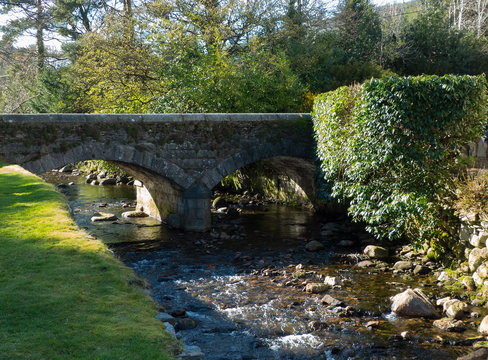 The small brook and stone bridge at the ancient Glendalough monastic site in the Wicklow mountains in Ireland