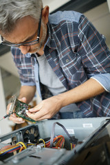 Technician repairing computer hardware