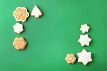 Frame made of tasty Christmas cookies on color background
