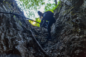 Hikers climbing on mountain wall