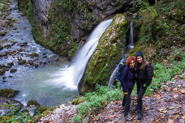 Girlfriends in holiday posing by the waterfall