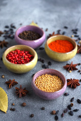 Spices in containers on a gray background