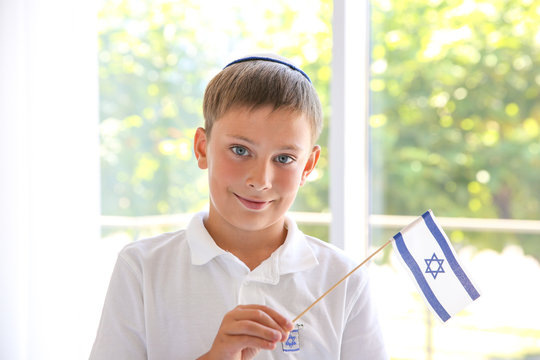 Jewish boy with flag at home