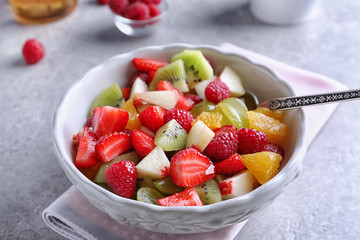 Bowl with delicious fruit salad on table