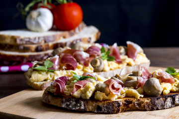 Toasts with iberian ham, eggs and mushrooms