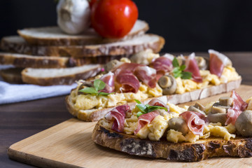 Toasts with iberian ham, eggs and mushrooms