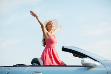 happy young woman in convertible car