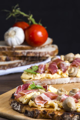 Toasts with iberian ham, eggs and mushrooms