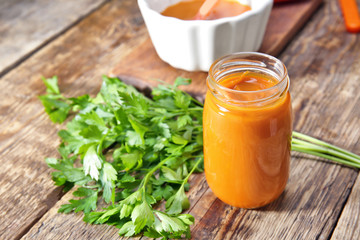 Jar with baby food on wooden table
