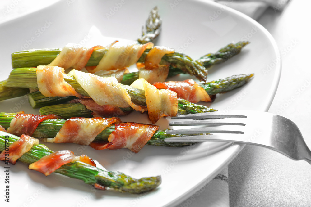 Sticker Plate with bacon wrapped asparagus on table, closeup