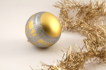 Christmas decoration. Golden ball on soft white background