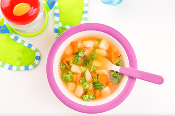 Plate of delicious baby soup on table