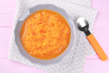 Plate of creamy baby carrot soup on table