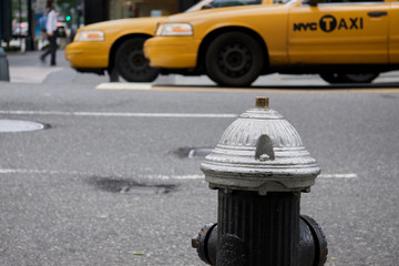 Water post and yellow cabs on a New York street