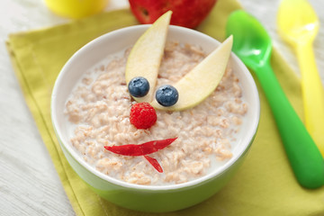 Creative oatmeal for children on table