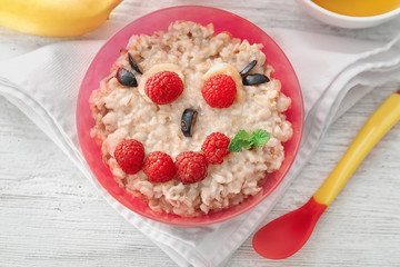 Creative oatmeal for children on table