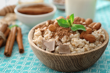Tasty oatmeal in bowl for breakfast, close up