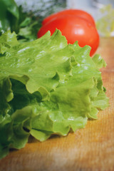 Leaves of green salad close-up. Vegetables for home cooking. Vertical photography.