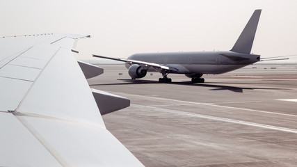 Passenger airplane in airport. View from plane window