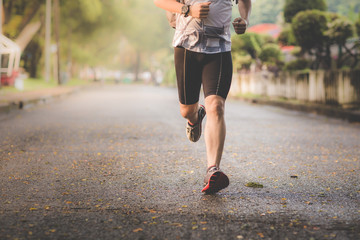 Fototapeta premium Athlete man runner running legs closeup on shoe,Men jogging in a park.