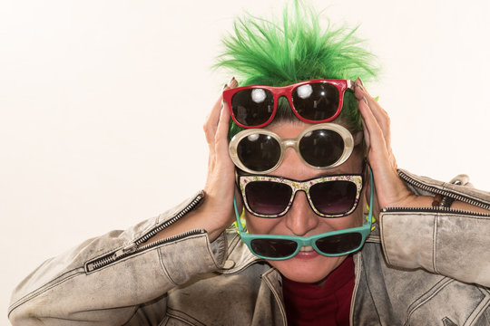 A crazy girl with green hair advertises various styles of glasses. The concept of fun and unexpected advertising.