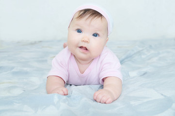 Happy smiling baby girl portrait with wryneck. Health care lifestyle.