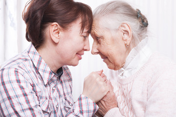 Seniors woman with her caregiver at home