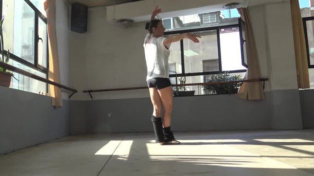 Ballet dancer practicing indoors.
