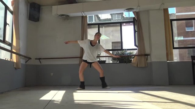 Ballet dancer practicing indoors.
