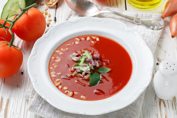Gazpacho. Gourmet tomato soup with fresh vegetables - cucumber, onion, Basil and pine nuts. Vegetarian cuisine. Selective focus