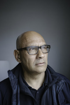 Portrait of bald man with glasses.