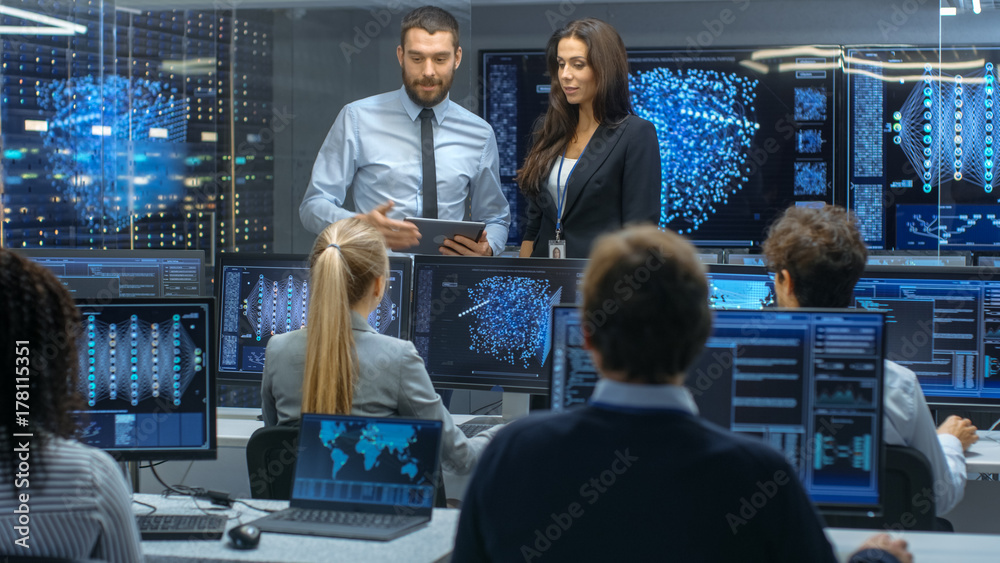 Poster Head of the Department and Project Manager Discuss Work Process Using Data on a Tablet Computer.Multi-Ethnic Team of Engineers Working at their Workstation.