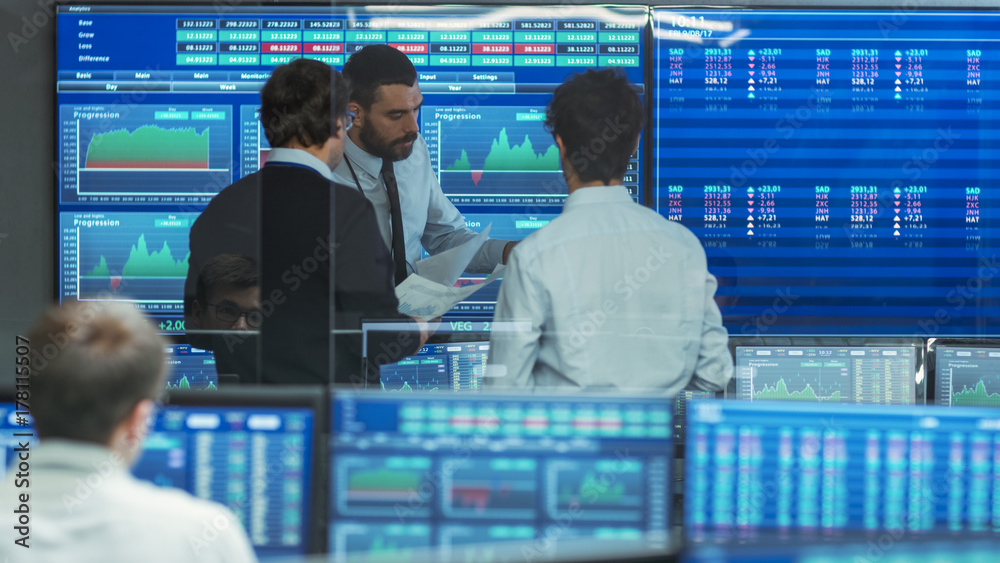 Poster three experienced stock traders talking business. they work for a big stock exchange firm. office is