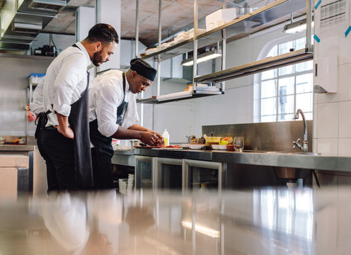 Chefs cooking food in commercial kitchen
