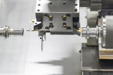 Close up of the CNC lathe jaw clamping  raw material steel rod .Steel Cylinder part after turning process. Hi-precision CNC machining concept.Raw material steel rod for CNC lathe precess