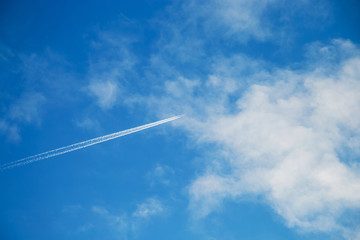 Trace from the plane in a blue sunny sky