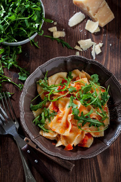 Pasta with tomato sauce and rocket salad
