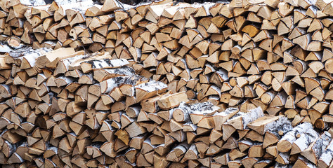 pile of chopped firewood Birch. Harvesting of firewood.