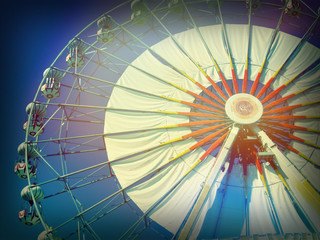 Old Vintage Ferris wheel over blue sky