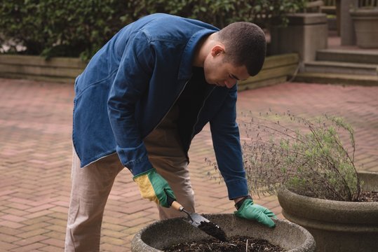 Man digging soil with spade
