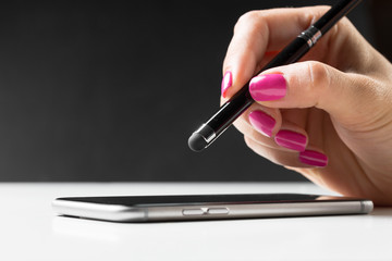 woman working with pen on smart mobile phone