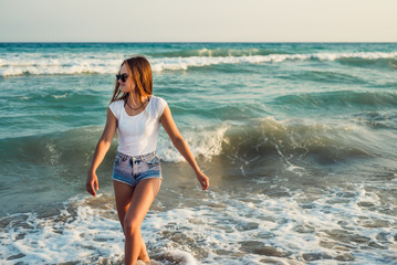 Girl With Long Hair on the background of the sea sunset
