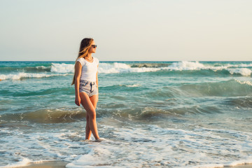 Girl With Long Hair on the background of the sea sunset

