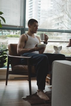 Man having breakfast in the living room