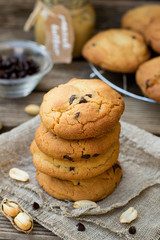 Peanut butter cookies with chocolate chips on wooden background