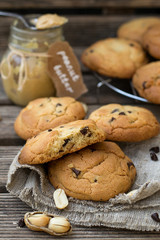 Peanut butter cookies with chocolate chips on wooden background