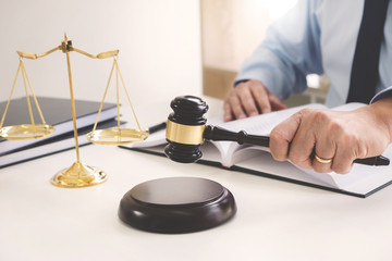 justice lawyer / judge gavel working with legal documents in a court room